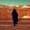 silhouette of person walking on ground at daytime